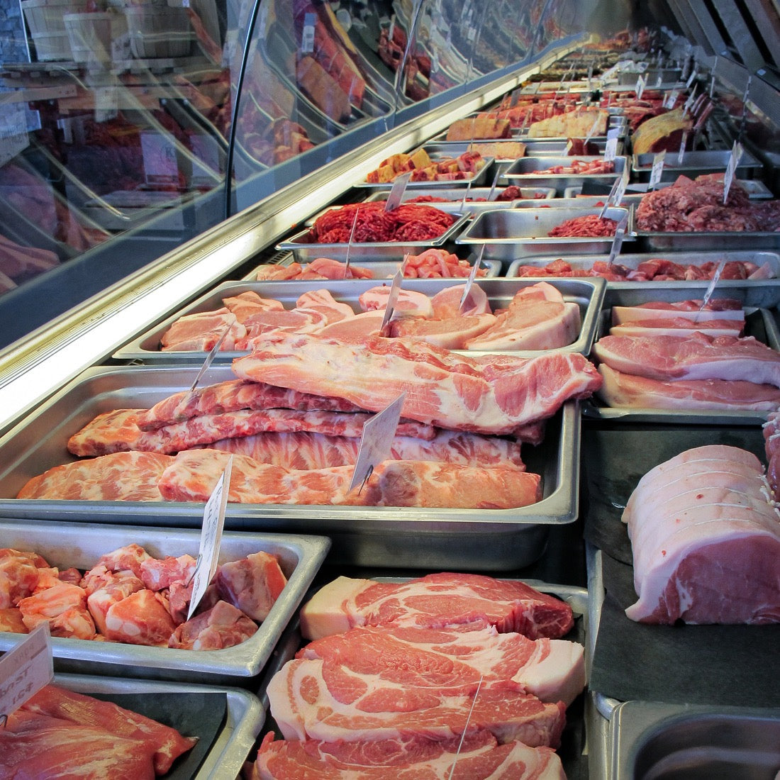 Inside of the meat counter at Osprey's Roost with trays of steaks, port roasts and different cuts of meat